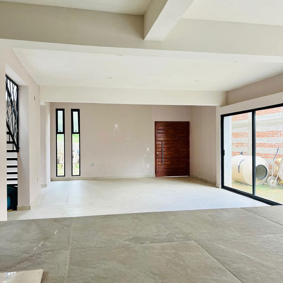 Interior of new San Luis Beltran Oaxaca real estate house for sale with kitchen and living room with windows, sliding glass door and natural light